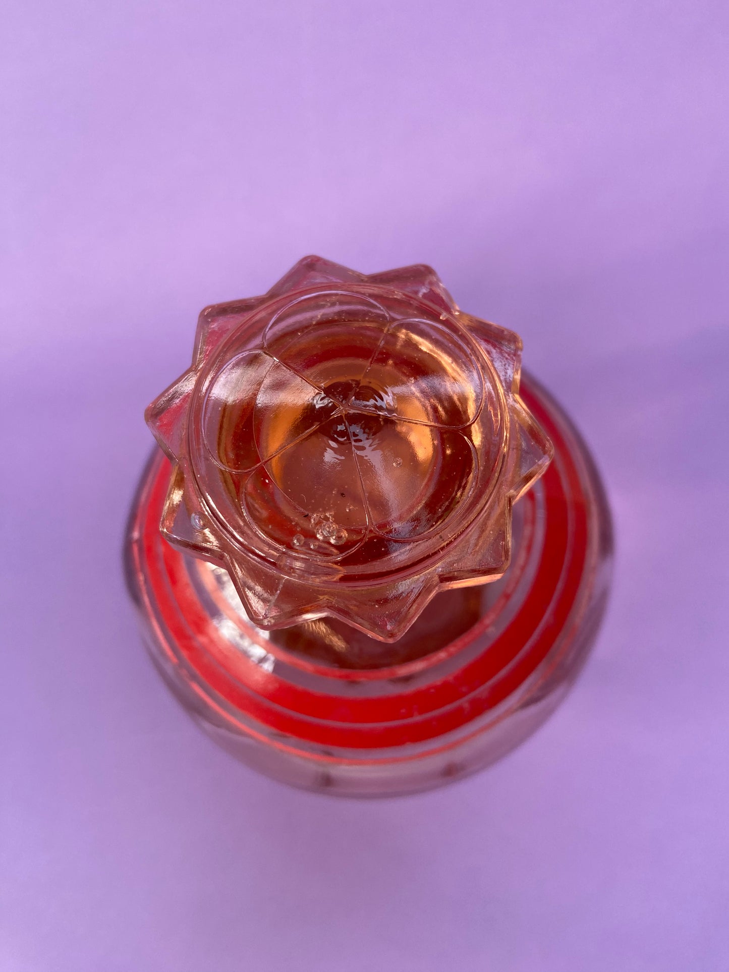 Small pink glass carafe with red line pattern