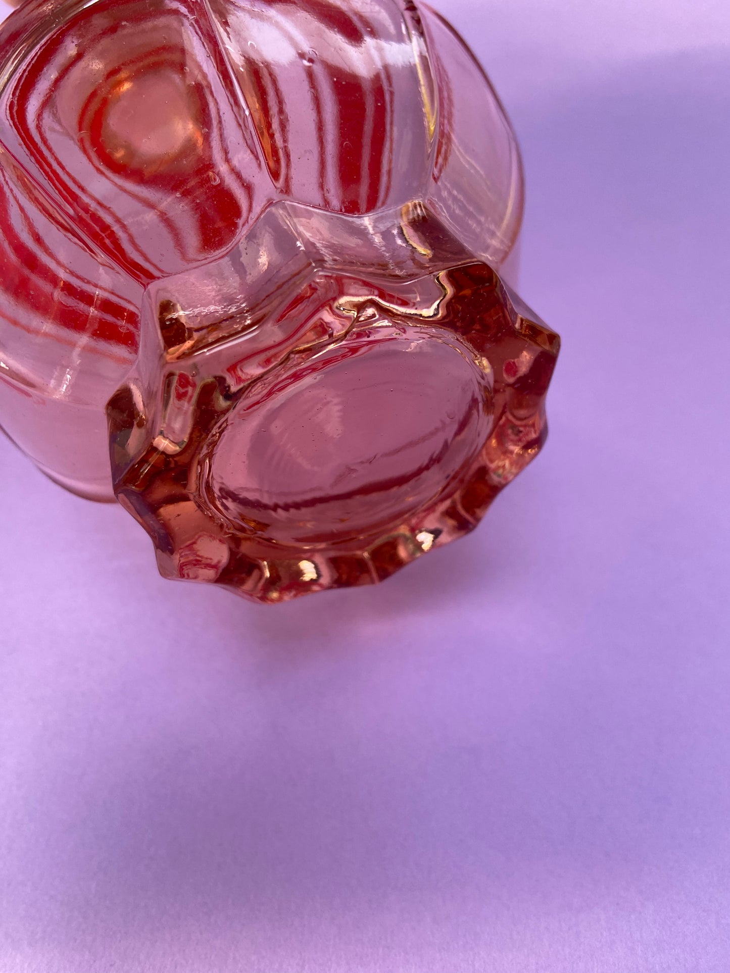 Small pink glass carafe with red line pattern