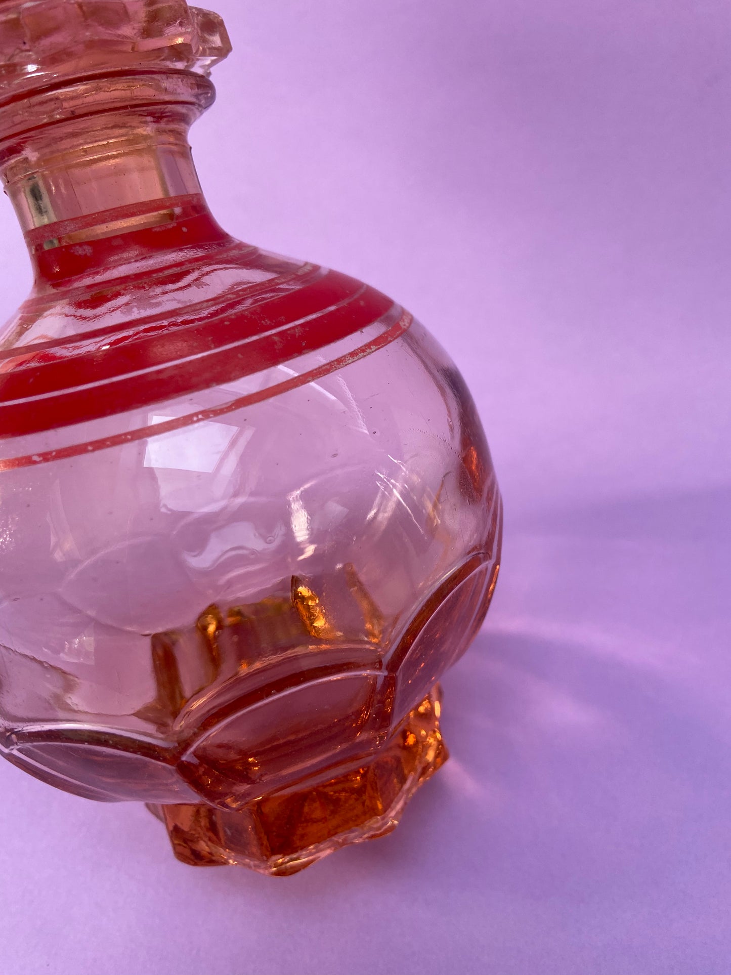 Small pink glass carafe with red line pattern