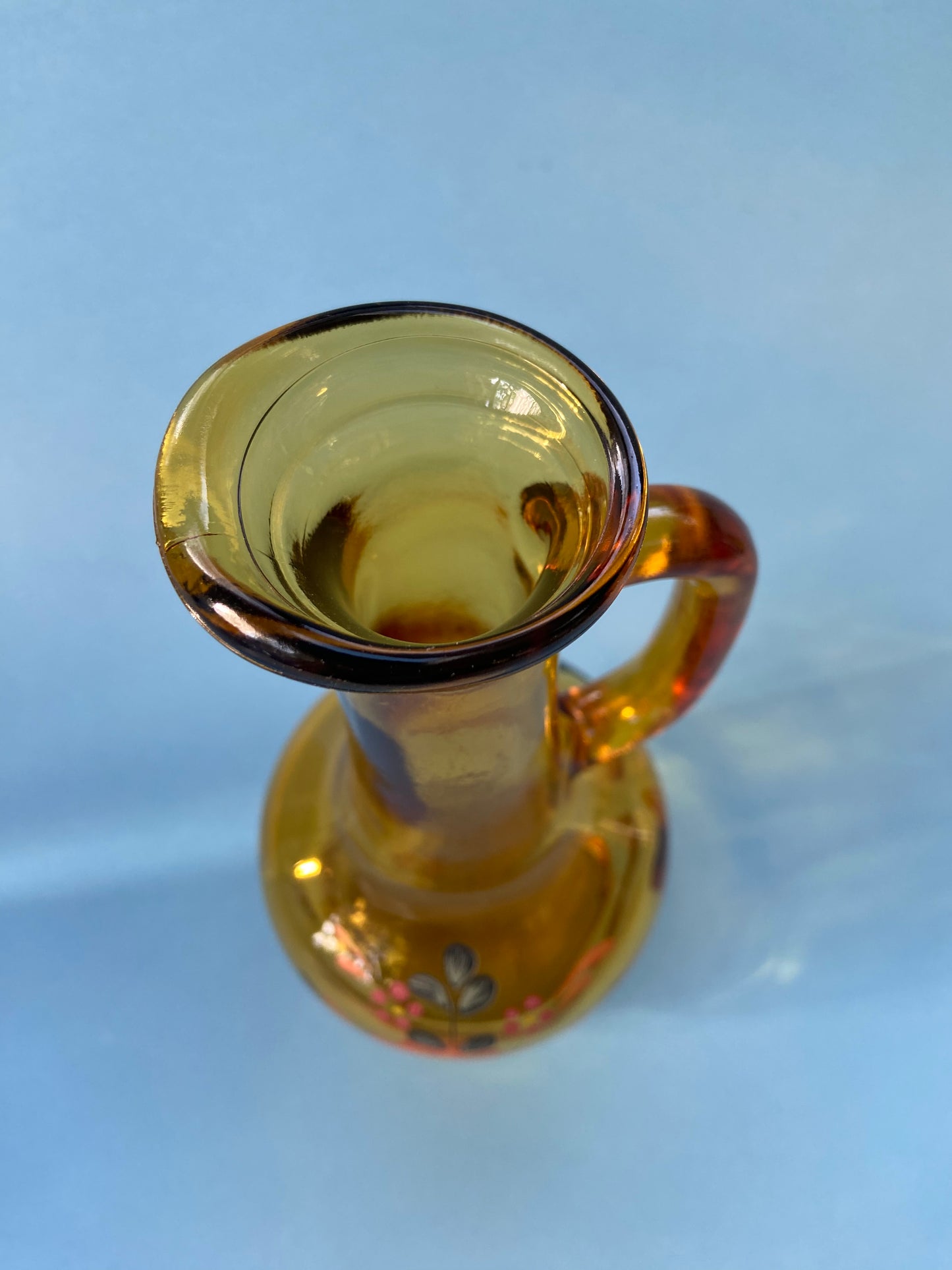 Amber glass carafe with floral pattern handle