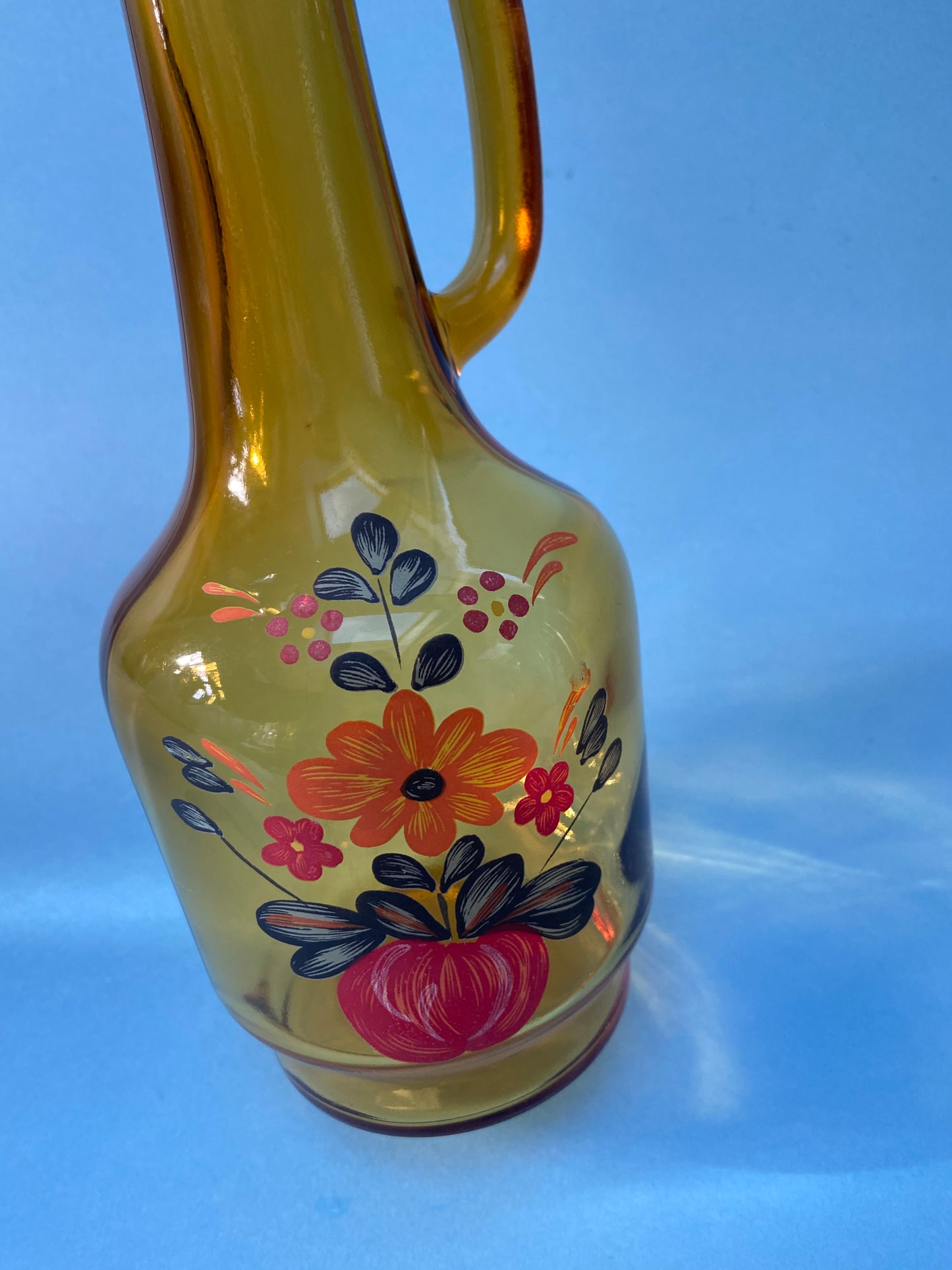 Amber glass carafe with floral pattern handle