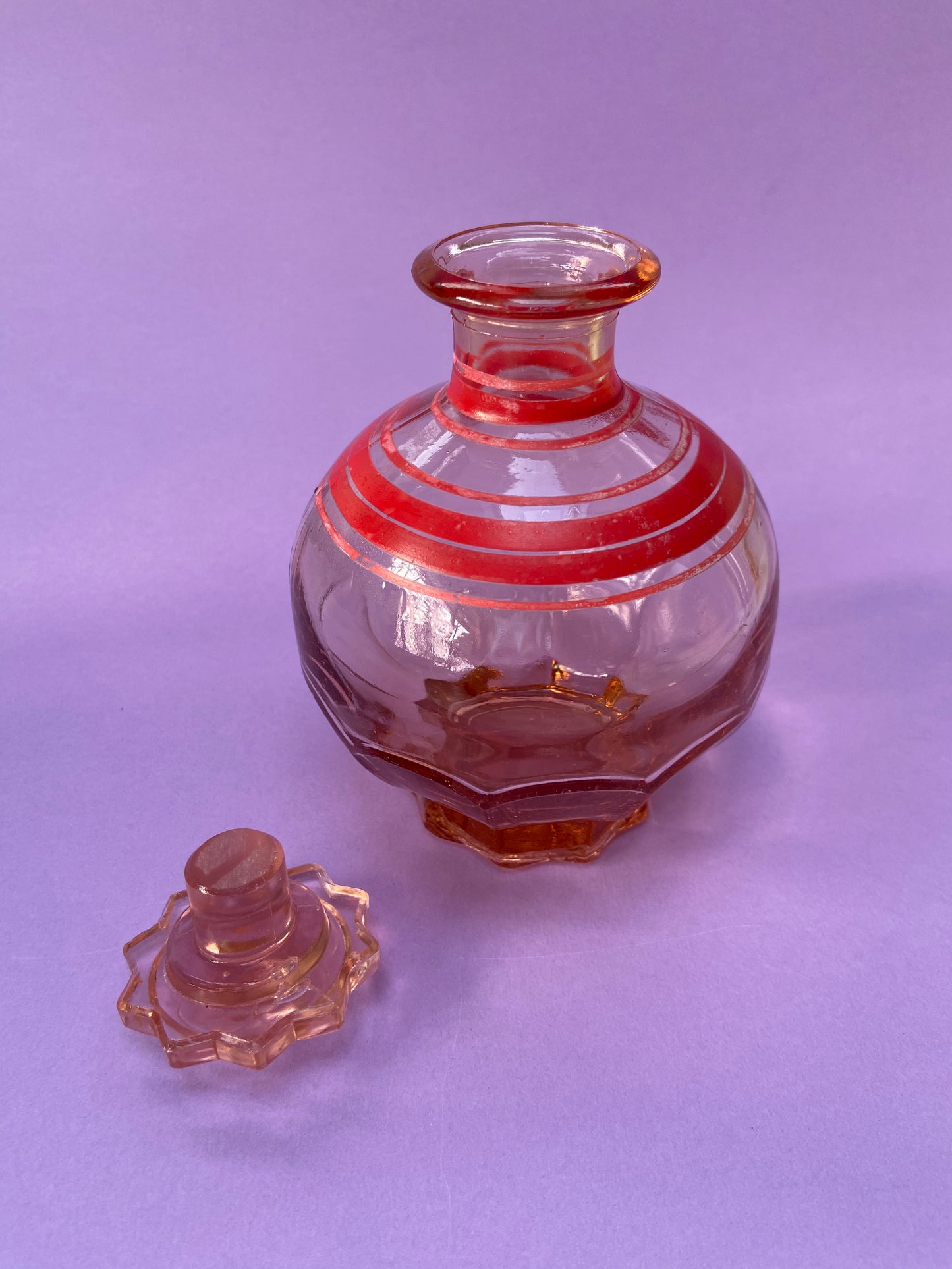 Small pink glass carafe with red line pattern