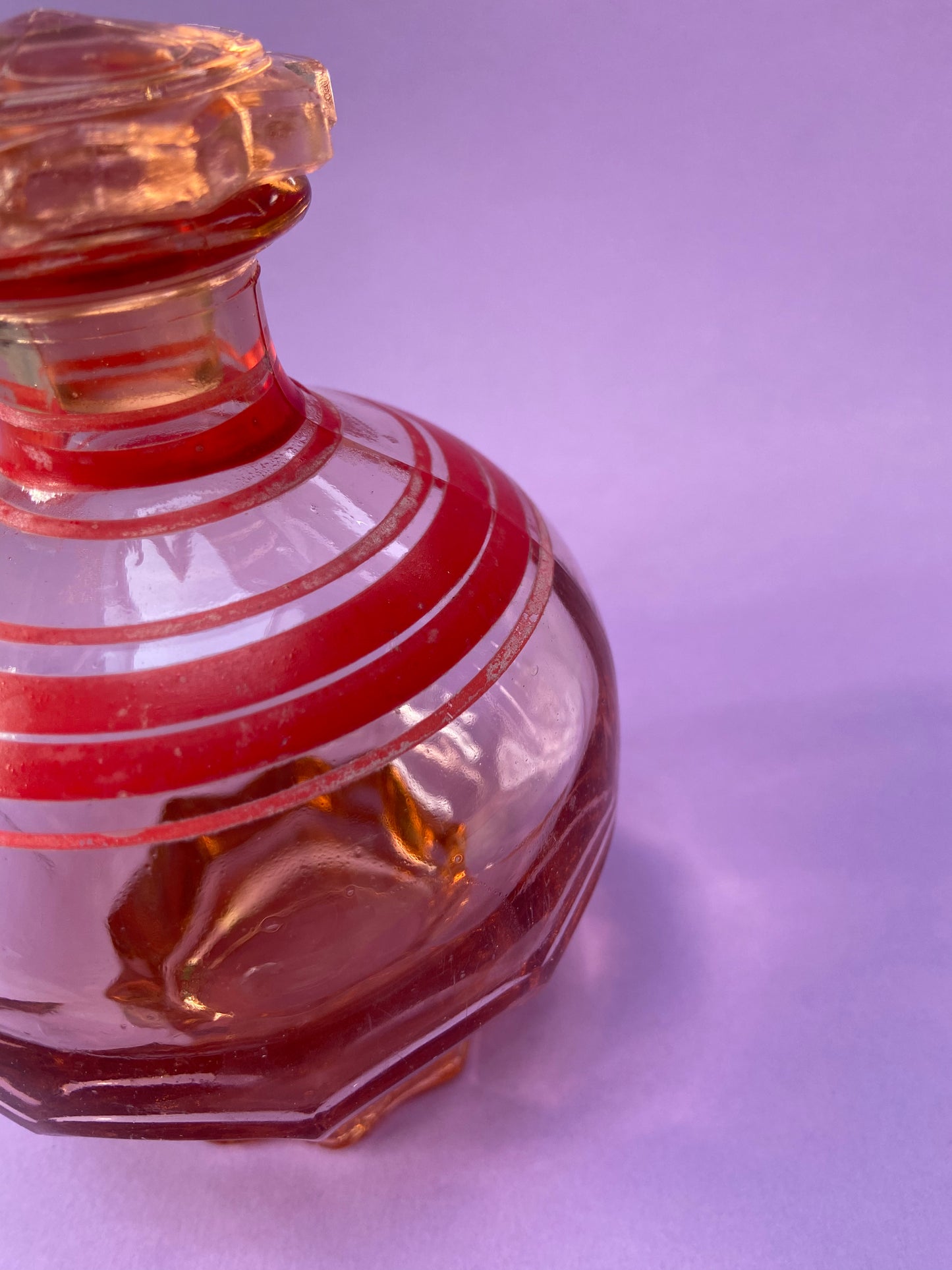 Small pink glass carafe with red line pattern