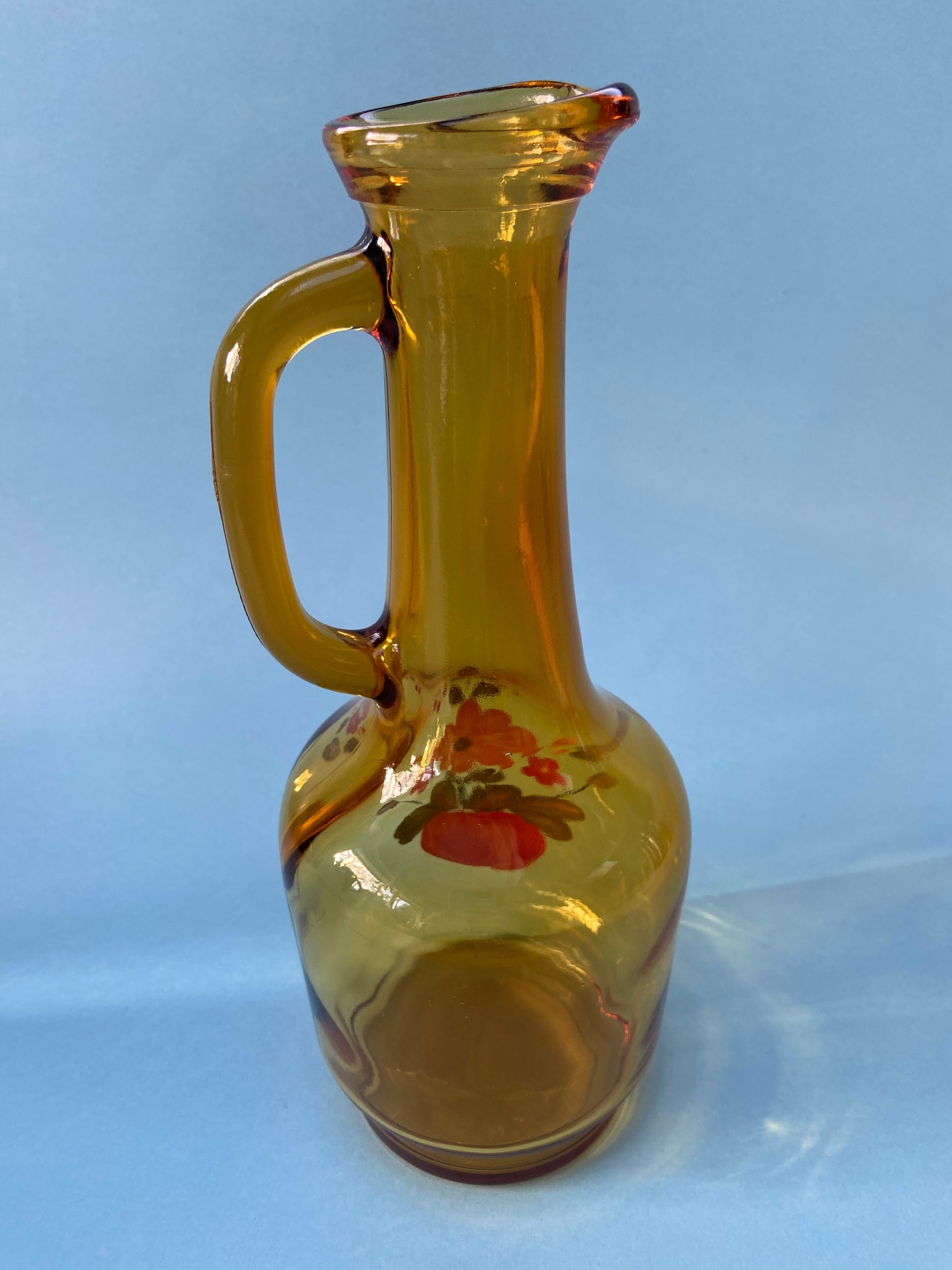 Amber glass carafe with floral pattern handle