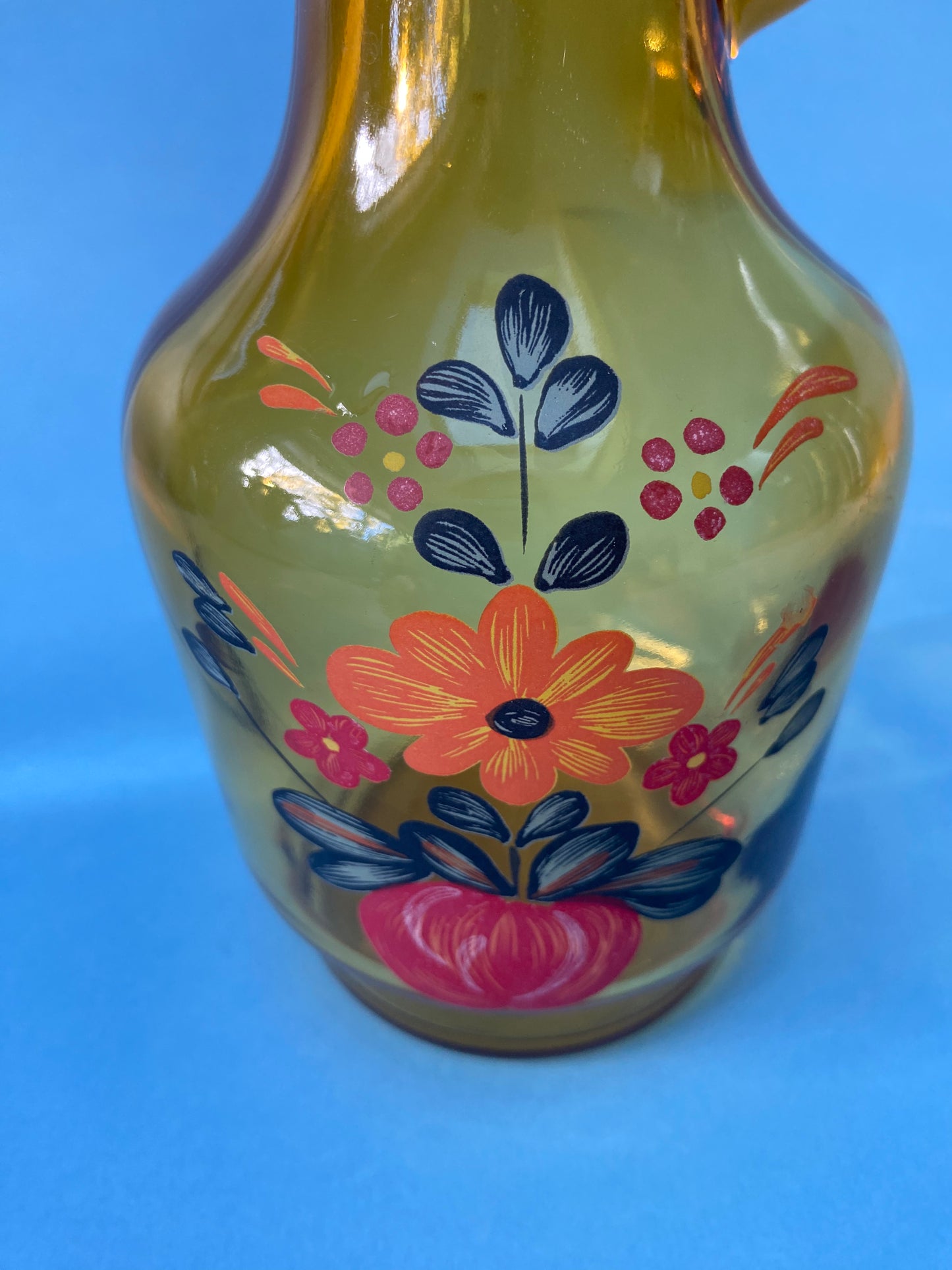 Amber glass carafe with floral pattern handle