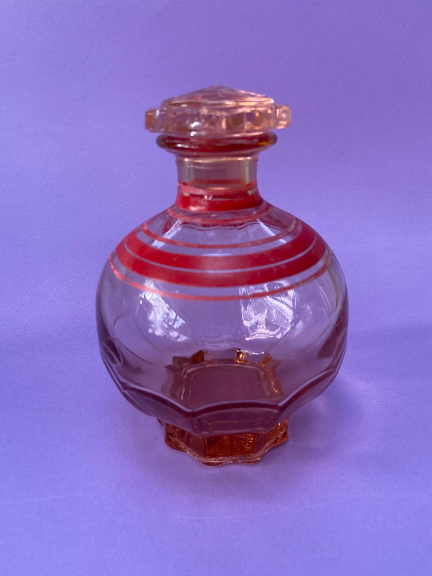 Small pink glass carafe with red line pattern