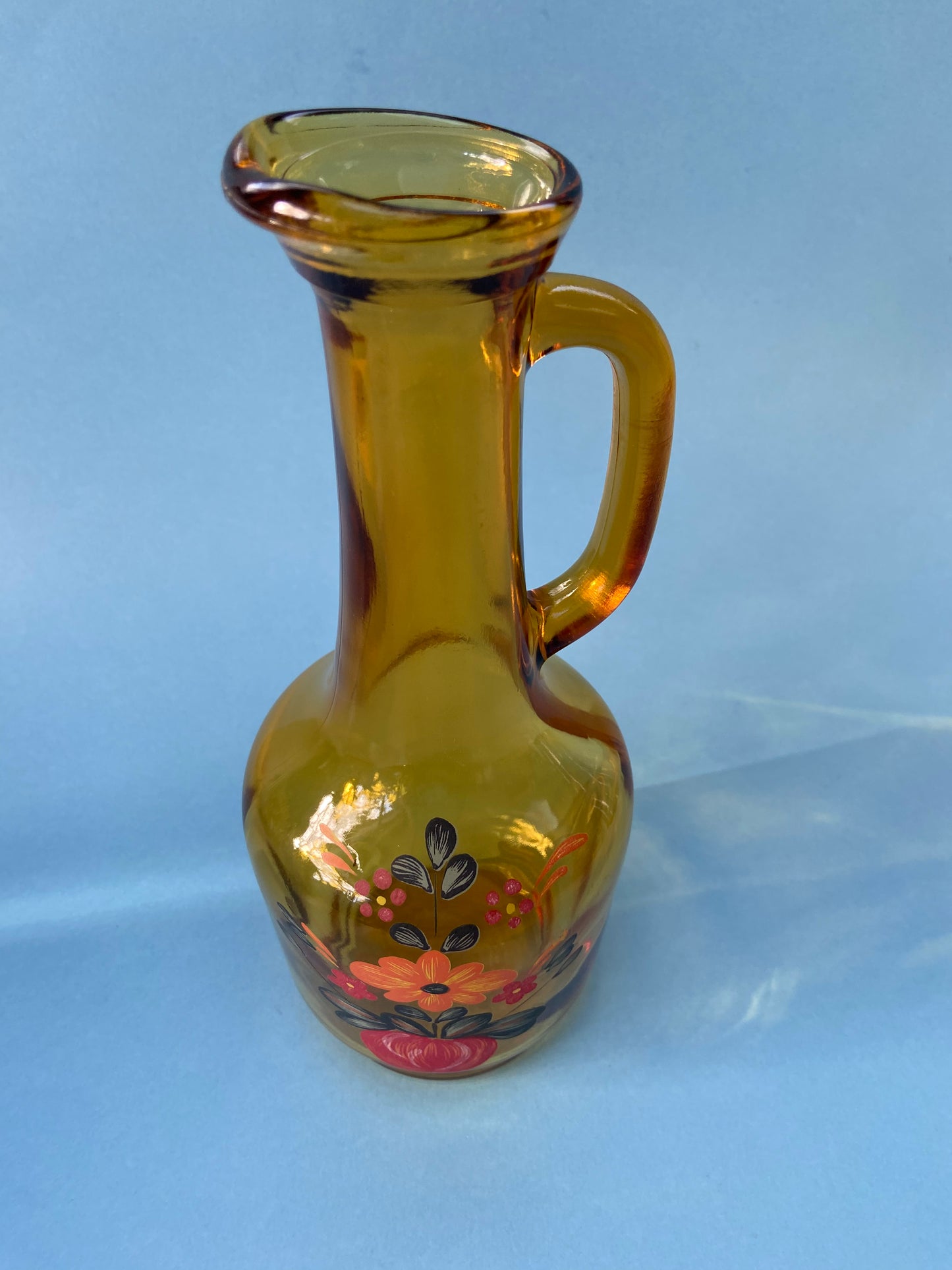 Amber glass carafe with floral pattern handle