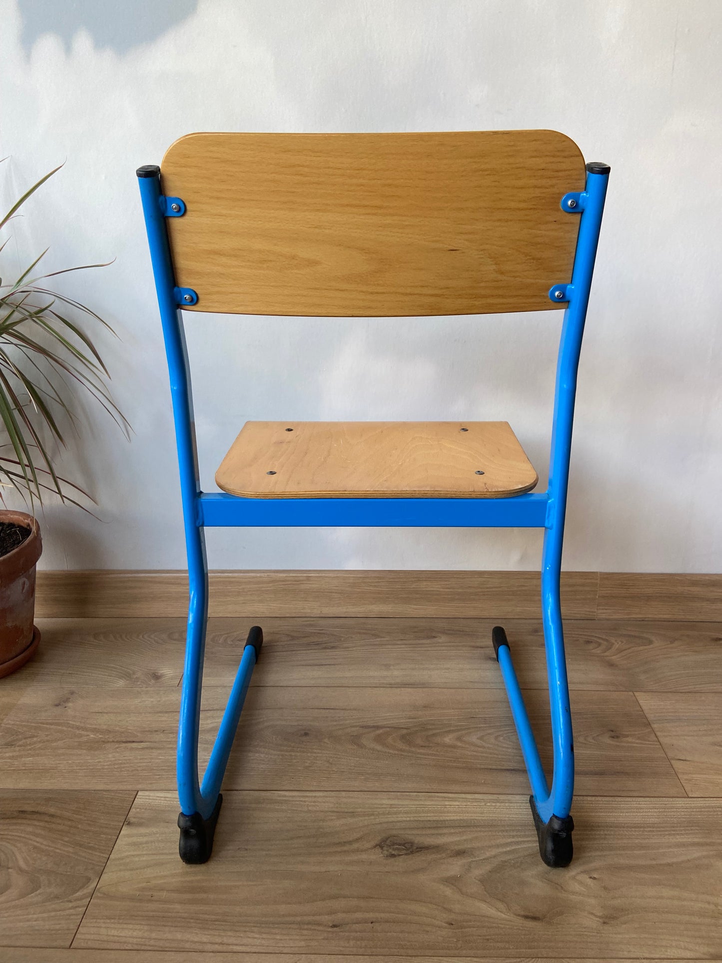 Wooden school chair with blue metal “sled” structure