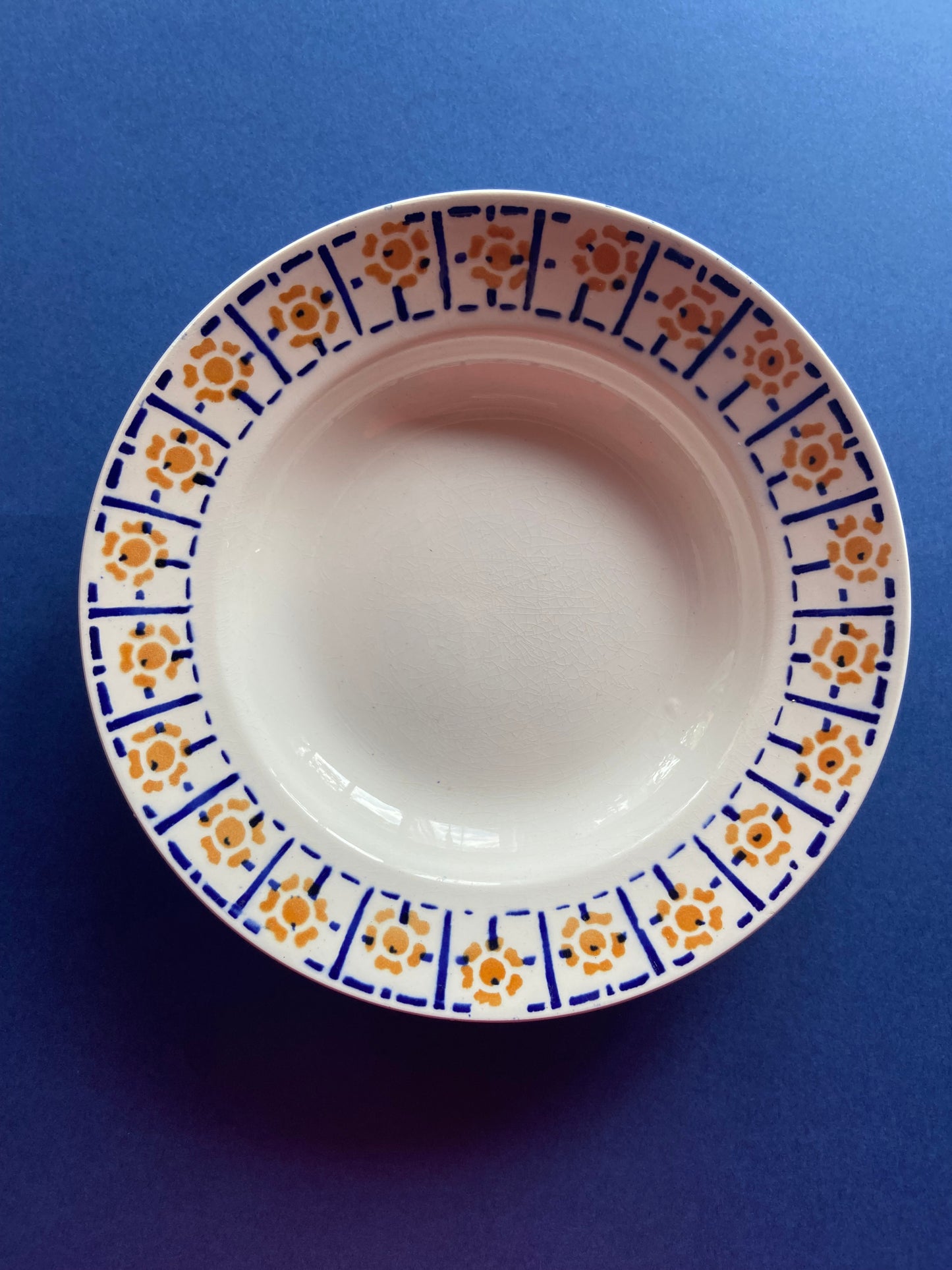 SAINT AMAND deep plate with orange and blue pattern