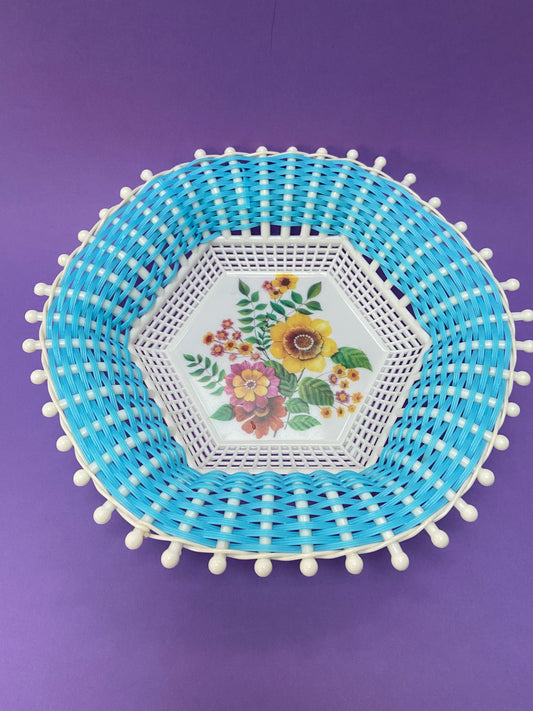 Vintage woven plastic basket in blue and floral pattern