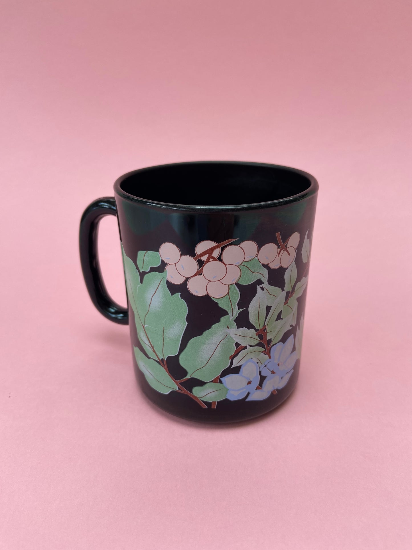 Black mug with pastel plant decor