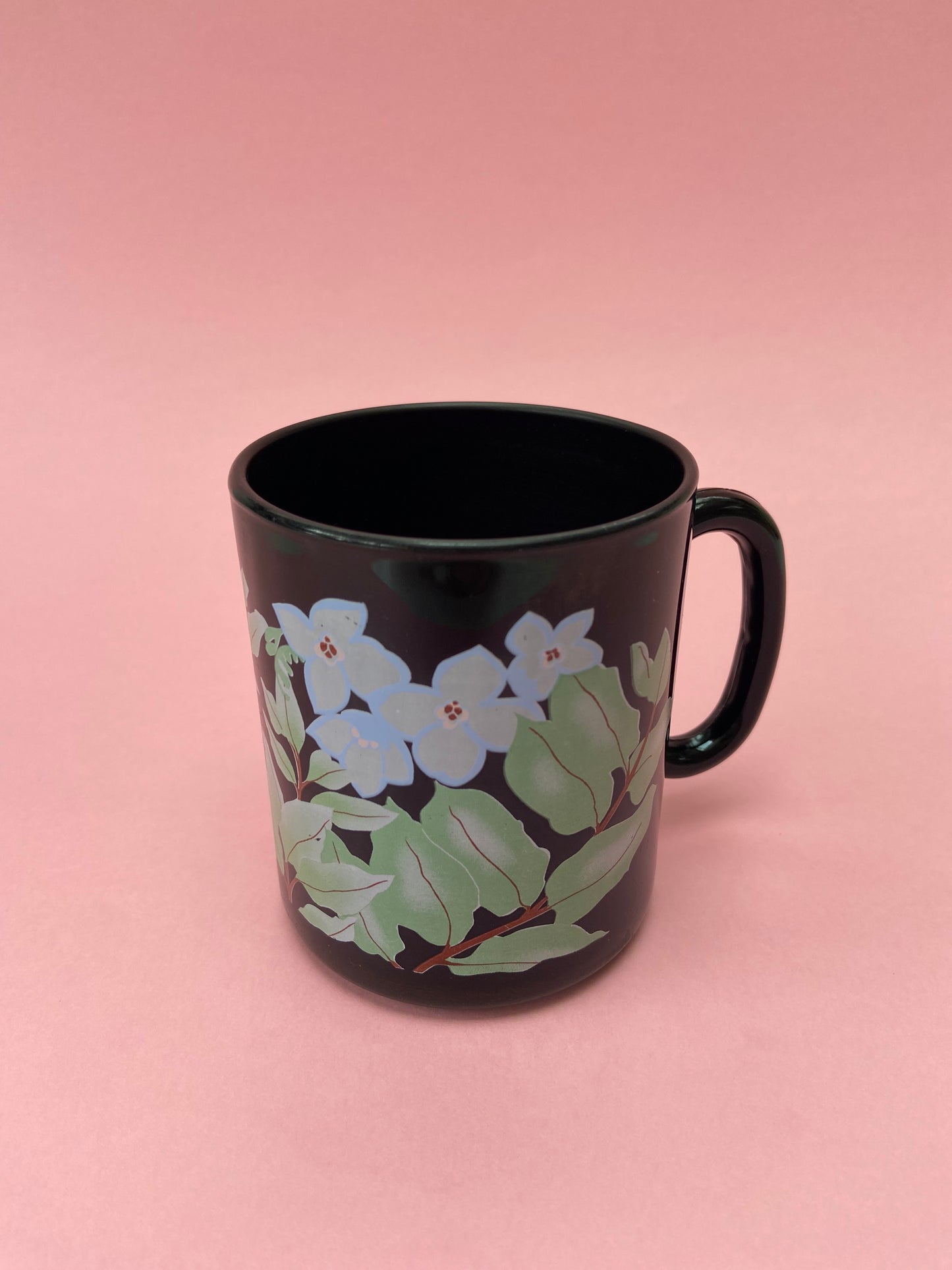 Black mug with pastel plant decor