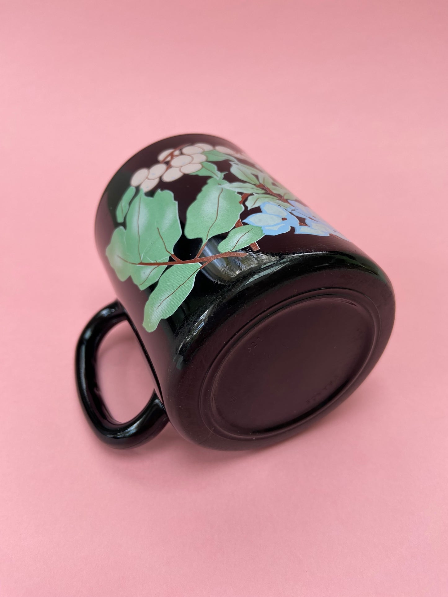 Black mug with pastel plant decor