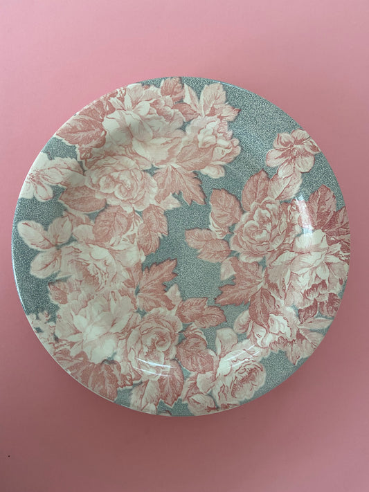 Flat plate with pink floral decoration on a gray background made in Italy