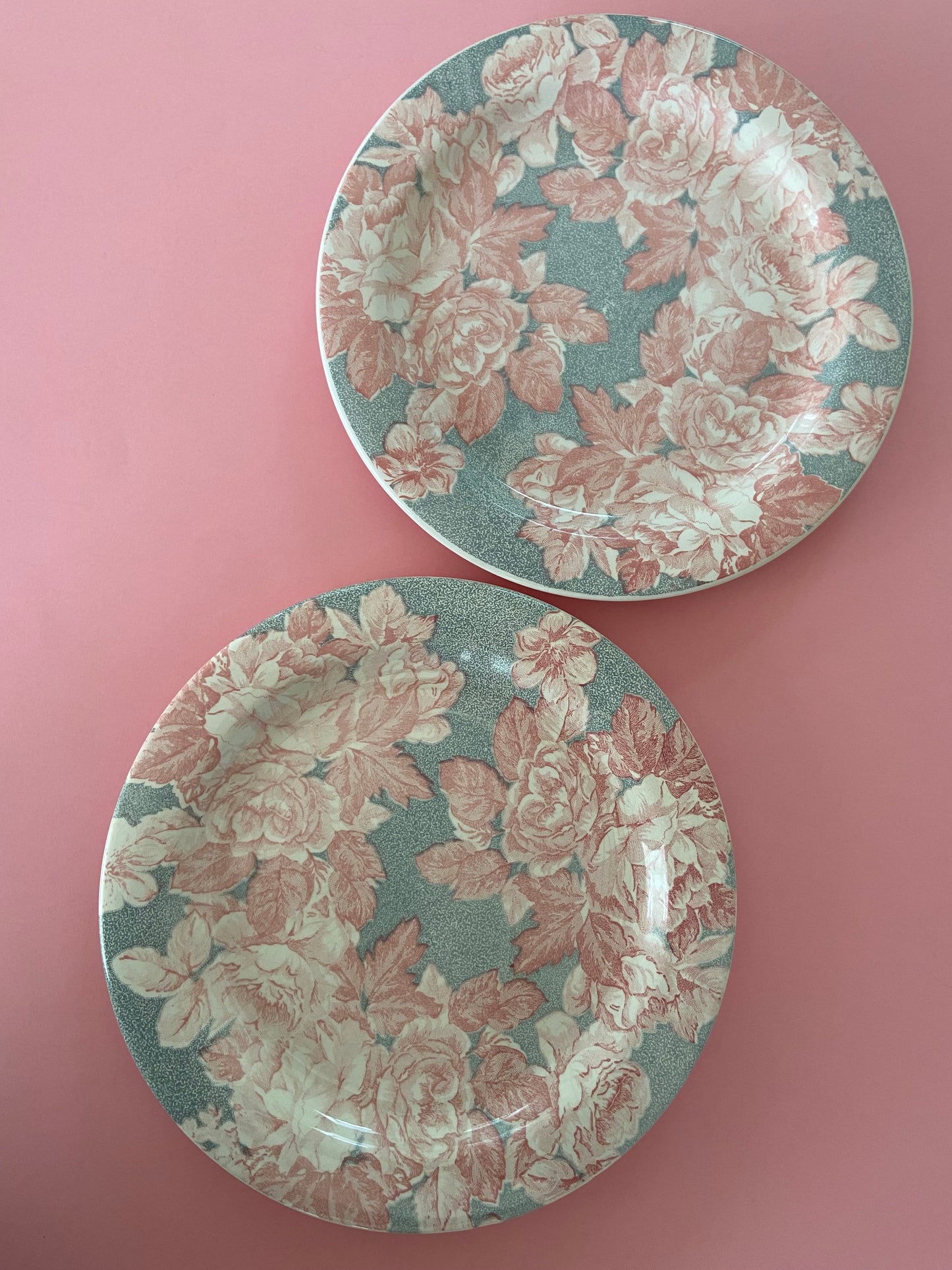 Flat plate with pink floral decoration on a gray background made in Italy