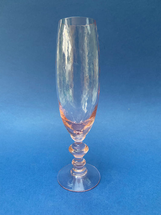 Champagne flute glass with pink reflection